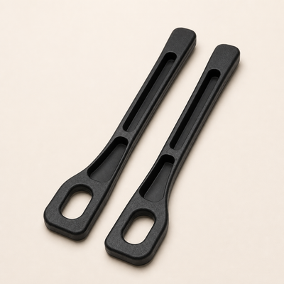Pair of black Seat Seal car-seat gap organizers on a warm studio background