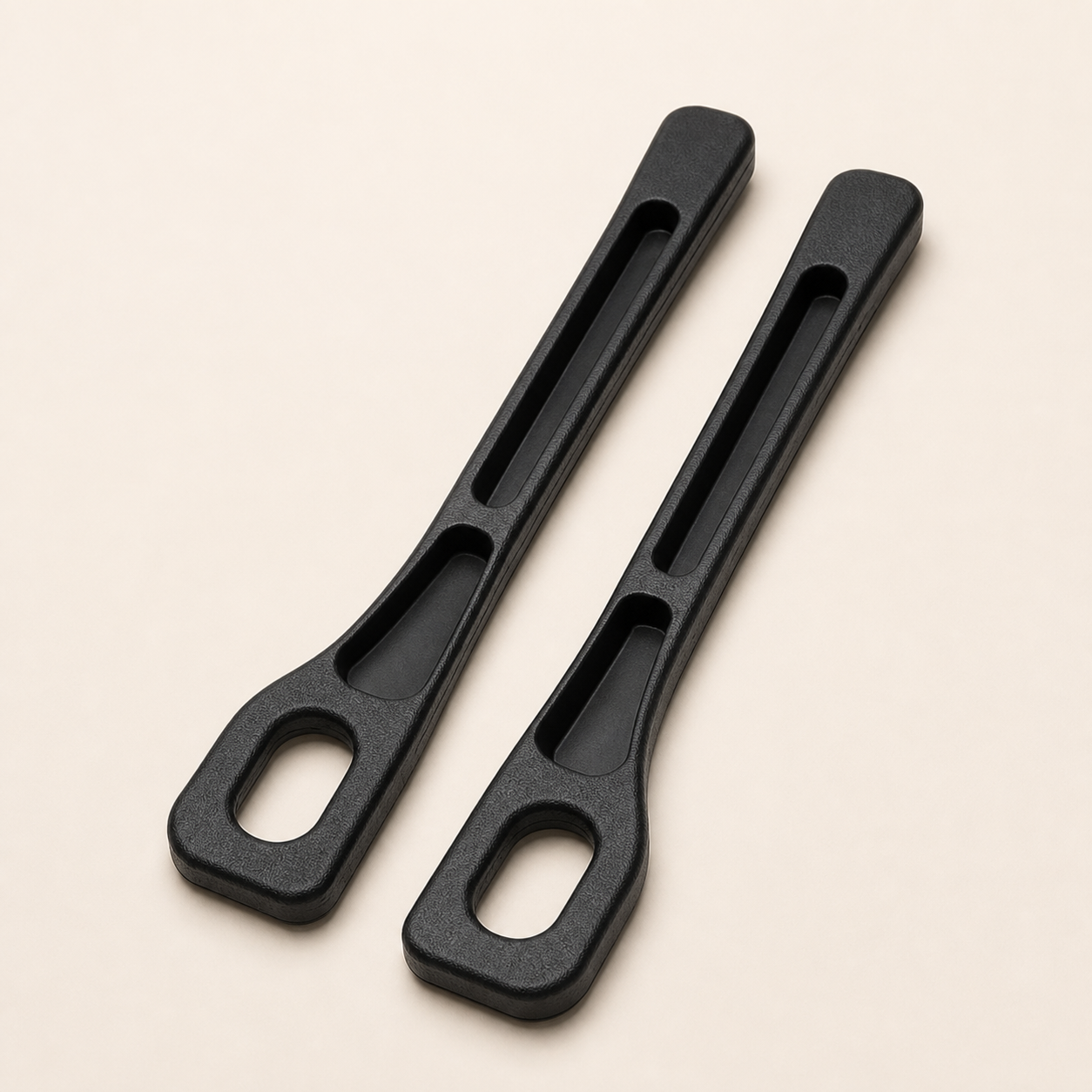 Pair of black Seat Seal car-seat gap organizers on a warm studio background